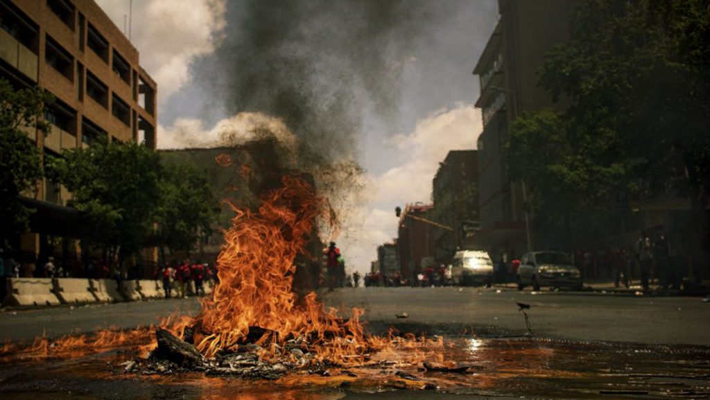 A fire burning in a city center after a riot